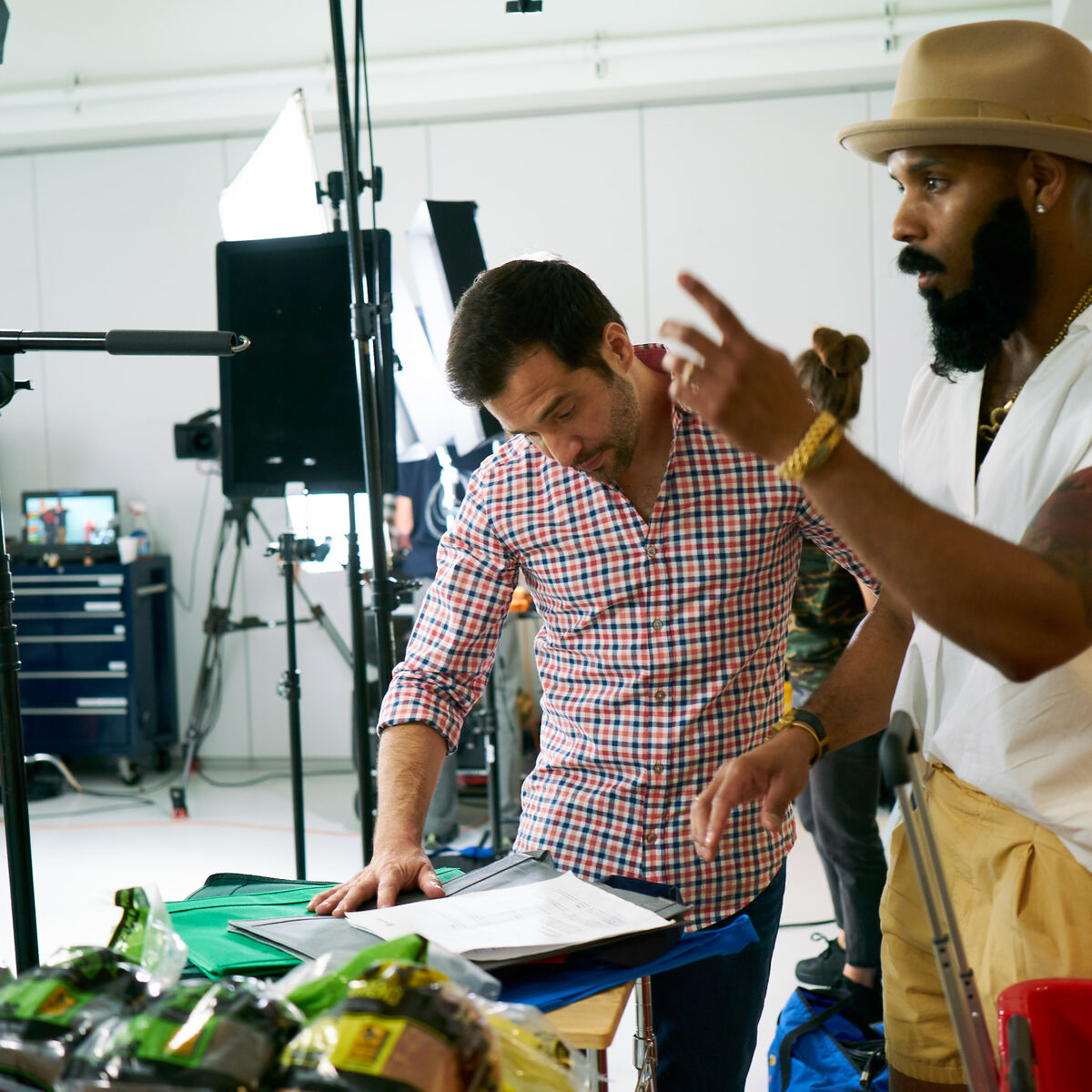 JD Roberto and crew reviewing notes in studio